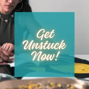 Image of a woman writing with text written Get Unstuck Now!